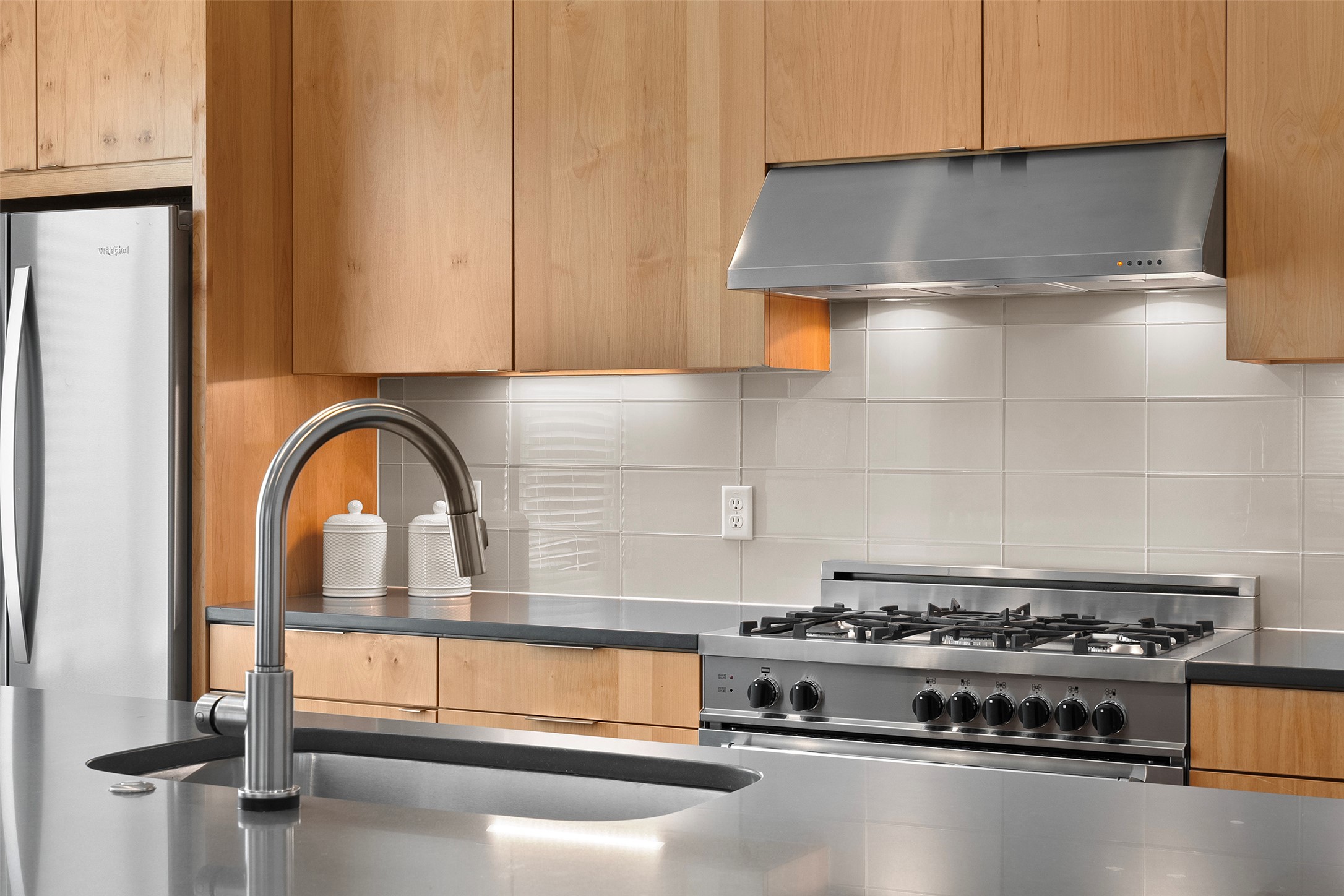 7813 Mullen Drive, Unit B Austin, TX 78757 - Photo 14 of 36 a kitchen with a stove and a white cabinet