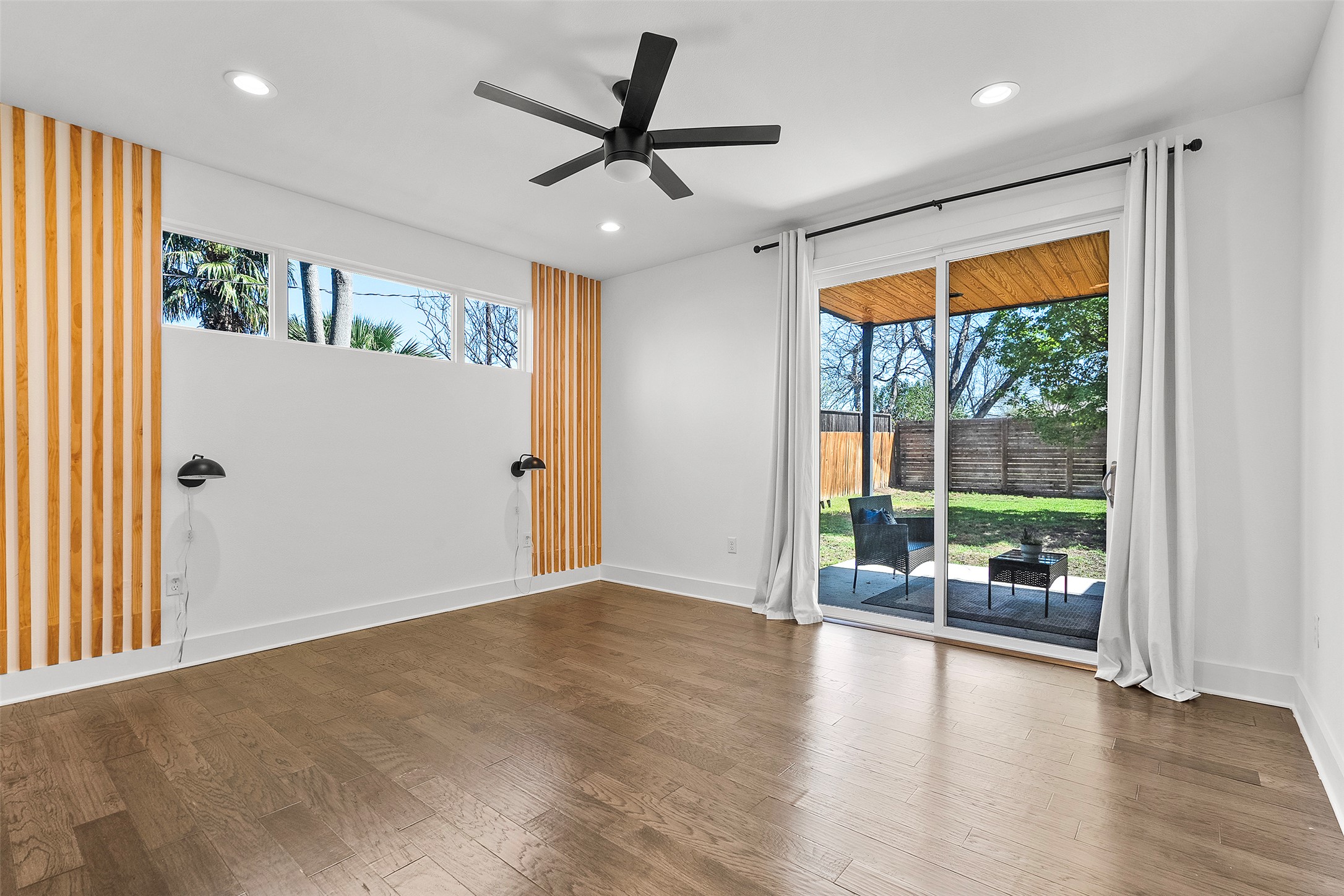 7813 Mullen Drive, Unit B Austin, TX 78757 - Photo 15 of 36 an empty room with floor to ceiling windows and view