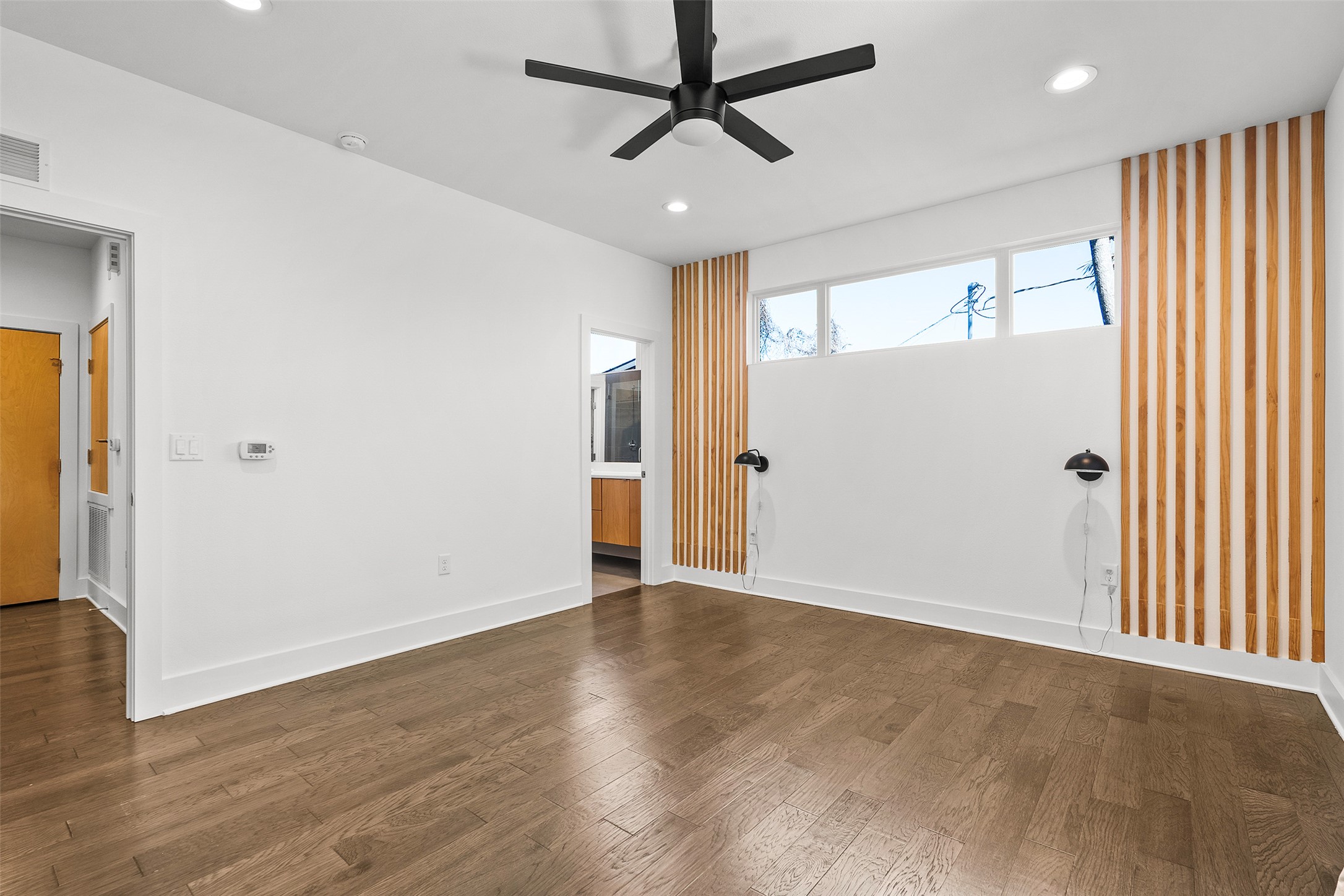 7813 Mullen Drive, Unit B Austin, TX 78757 - Photo 16 of 36 wooden floor in an empty room with a window