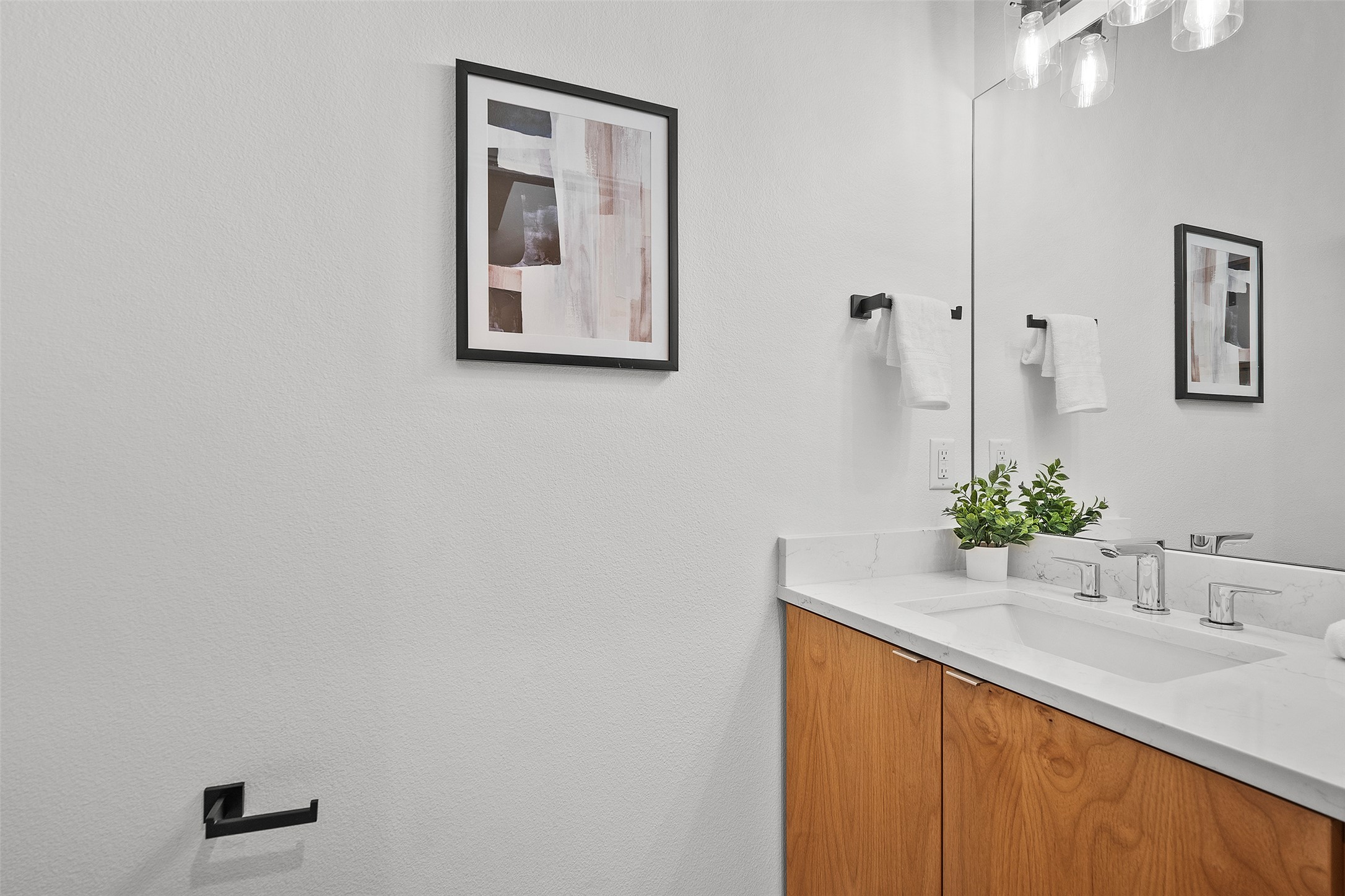 7813 Mullen Drive, Unit B Austin, TX 78757 - Photo 18 of 36 a bathroom with a sink and a mirror