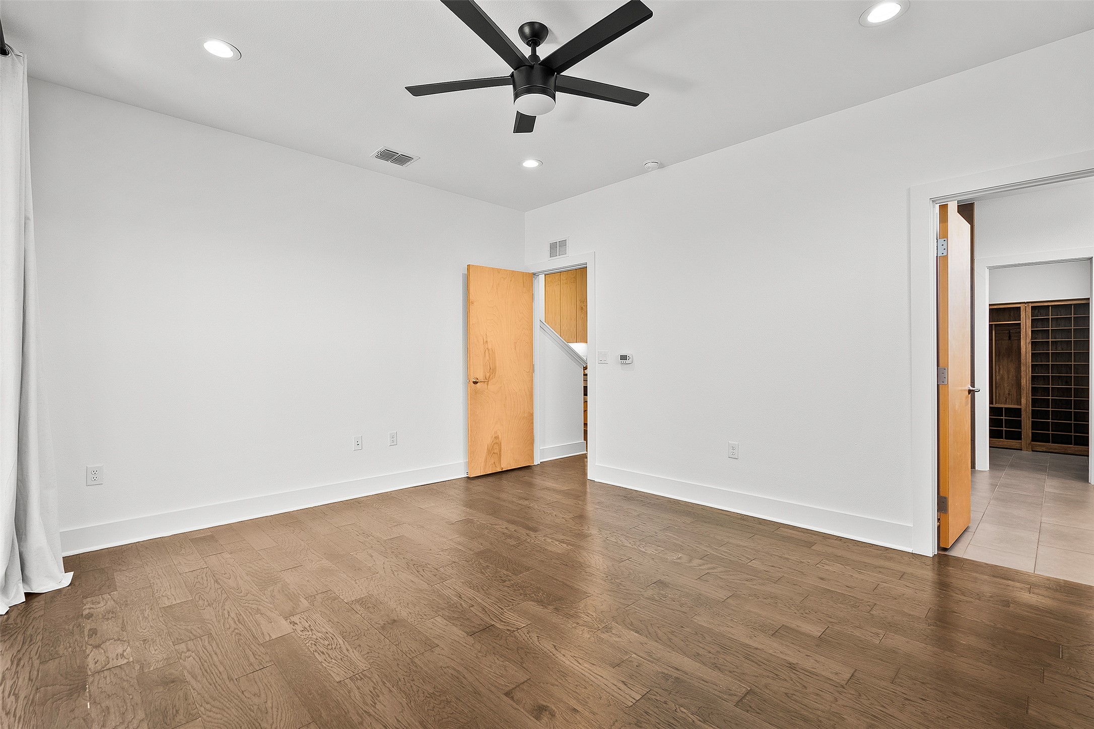7813 Mullen Drive, Unit B Austin, TX 78757 - Photo 19 of 36 an empty room with closet and a ceiling fan