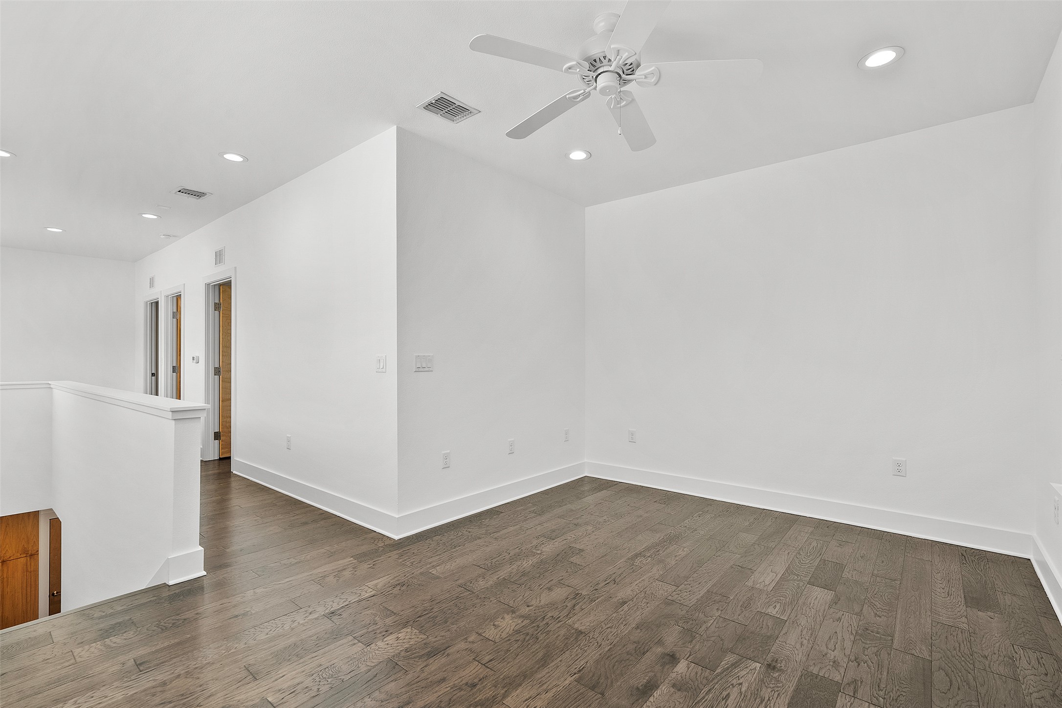 7813 Mullen Drive, Unit B Austin, TX 78757 - Photo 24 of 36 an empty room with wooden floor and ceiling fan