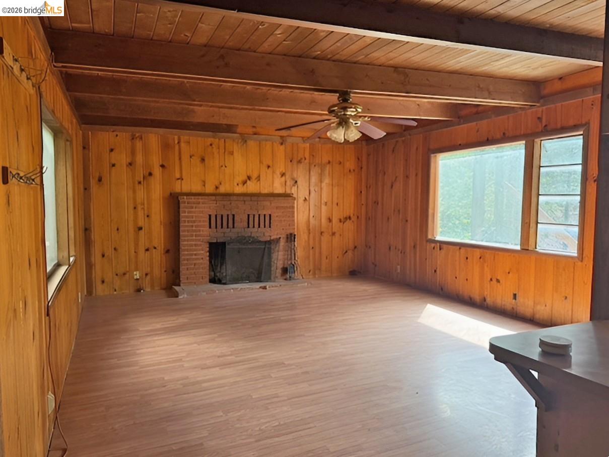 20693 Muheli Road Mi Wuk Village, CA 95346 - Photo 8 of 15 a view of an empty room with a fireplace and a window
