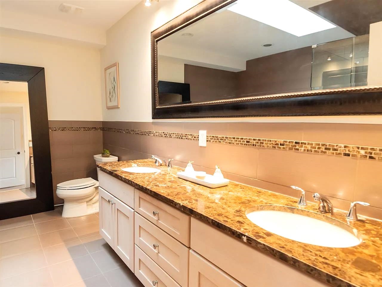 21 Jacob's Landing Way, Unit 21 Secaucus, NJ 07094 - Photo 12 of 19 a bathroom with a granite countertop sink and a mirror