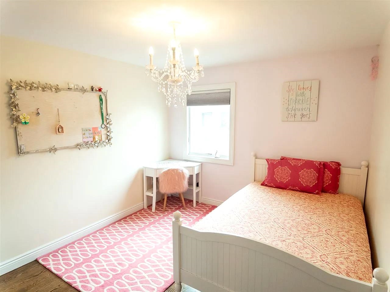 21 Jacob's Landing Way, Unit 21 Secaucus, NJ 07094 - Photo 13 of 19 a bedroom with a bed chandelier and a window