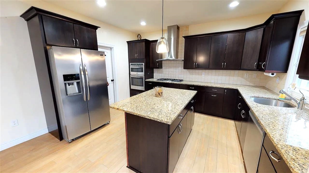 21 Jacob's Landing Way, Unit 21 Secaucus, NJ 07094 - Photo 5 of 19 a kitchen with stainless steel appliances granite countertop a refrigerator and a microwave