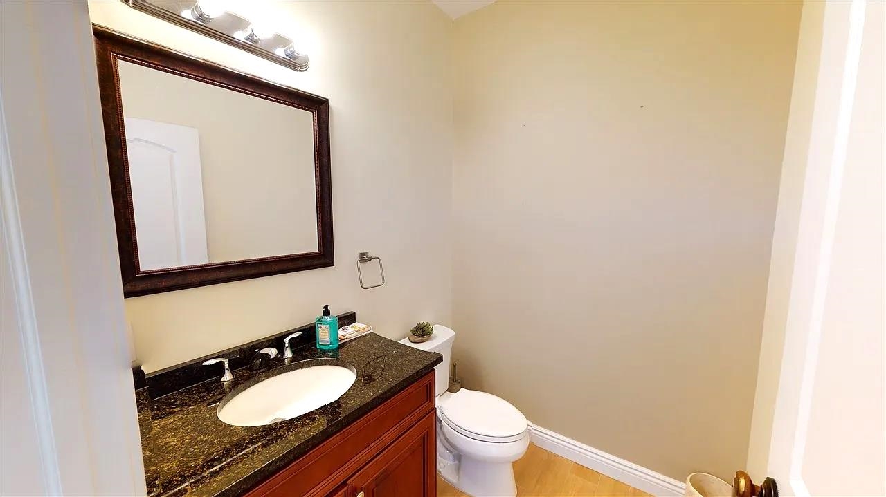 21 Jacob's Landing Way, Unit 21 Secaucus, NJ 07094 - Photo 8 of 19 a bathroom with a granite countertop sink mirror vanity and toilet