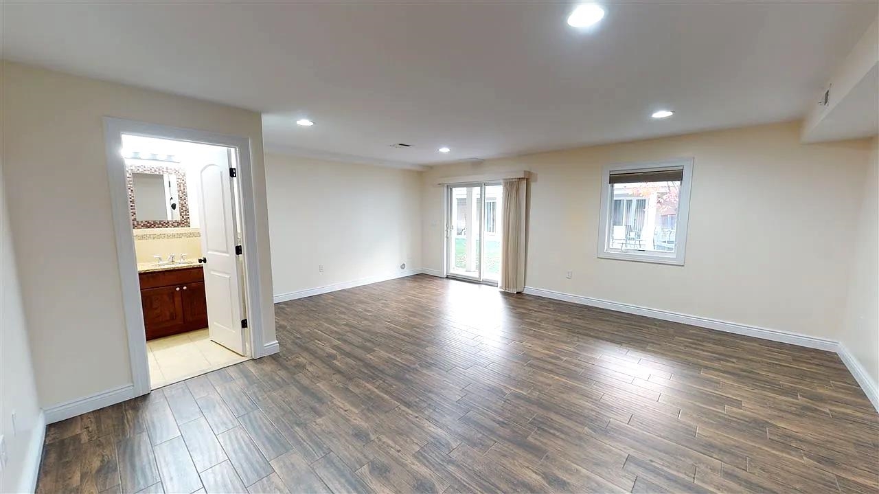21 Jacob's Landing Way, Unit 21 Secaucus, NJ 07094 - Photo 9 of 19 a view of an empty room with wooden floor and a window