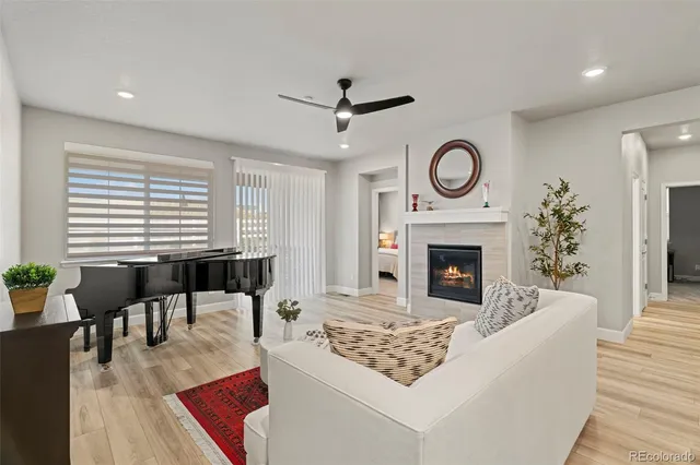 a living room with furniture a fireplace and a table