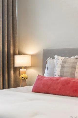 a bedroom with a bed and a night stand