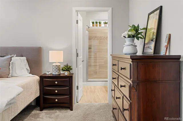a bedroom with a bed table closet and window