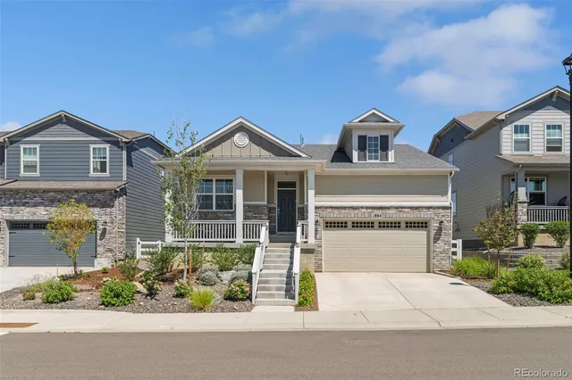 a front view of a house with a garden and plants