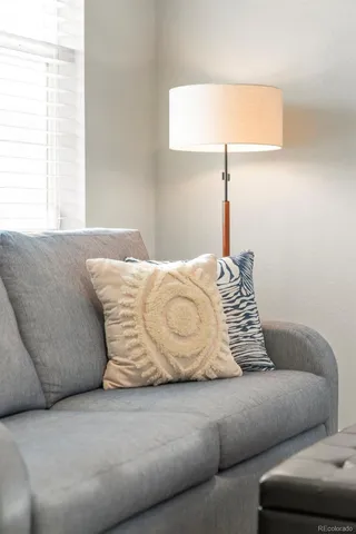 a bedroom with a bed couch and a window