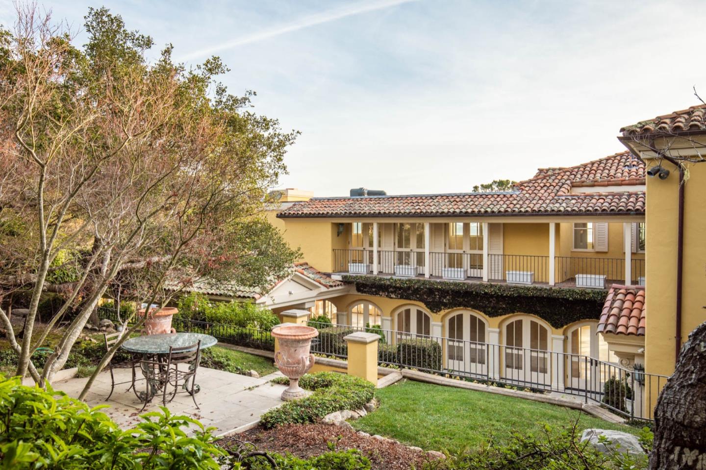 1491 Bonifacio Road Pebble Beach, CA 93953 - Photo 6 of 31 a front view of a house with a garden