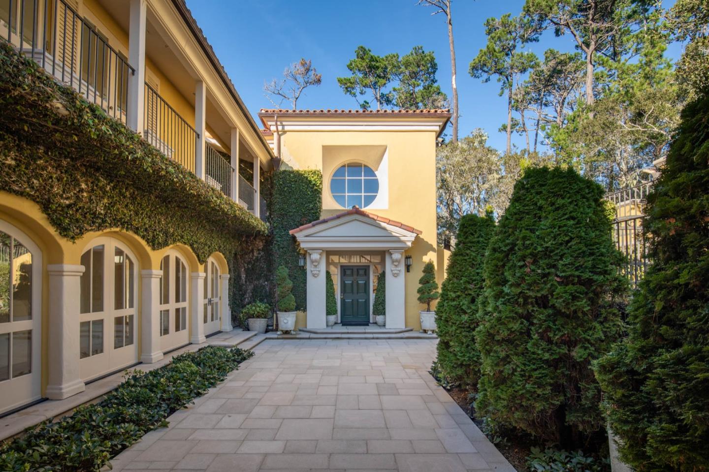 1491 Bonifacio Road Pebble Beach, CA 93953 - Photo 9 of 31 a view of a building with garden plants and large tree