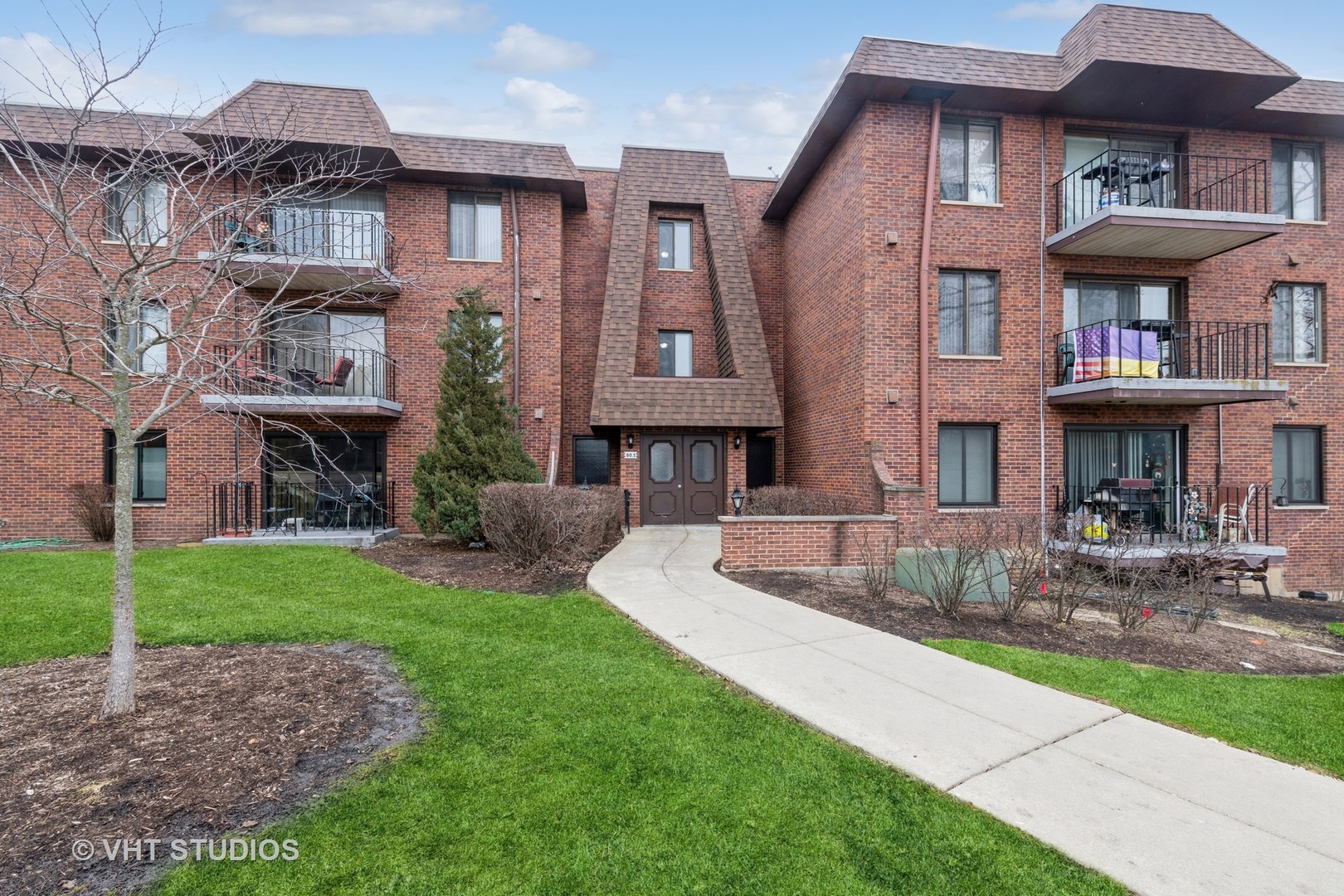 80 South Pleasant Road, Unit 304 Lake Zurich, IL 60047 - Photo 1 of 12 a front view of a brick house with a yard