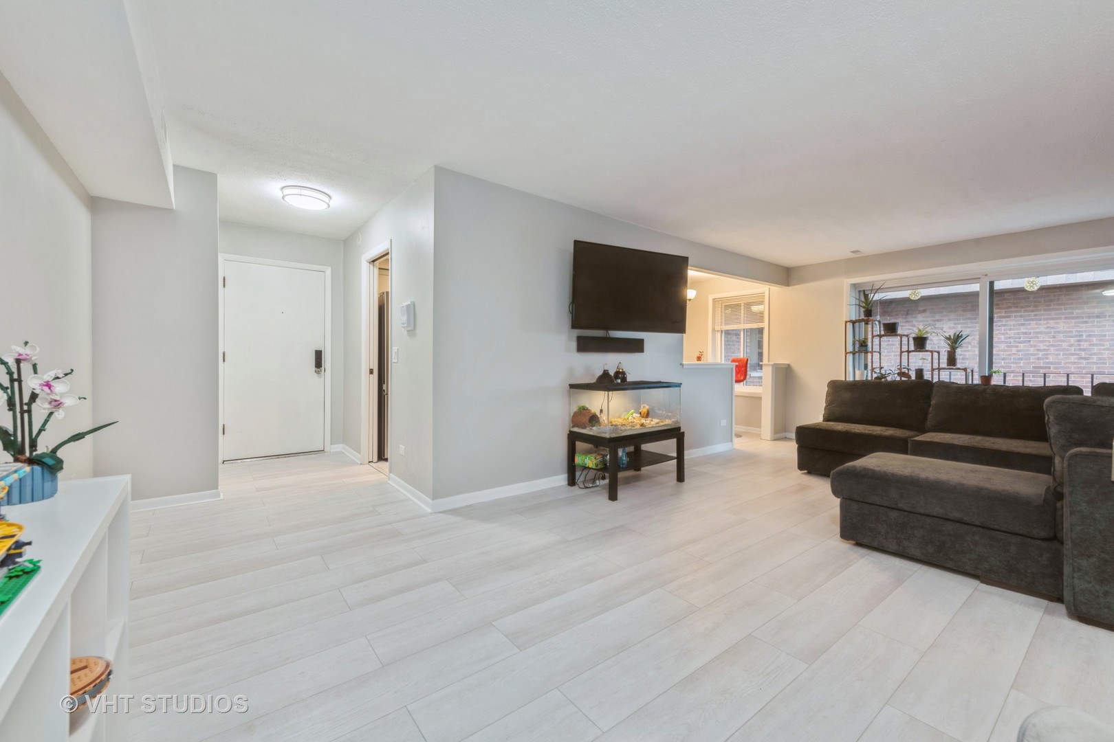80 South Pleasant Road, Unit 304 Lake Zurich, IL 60047 - Photo 2 of 12 a living room with furniture and a flat screen tv