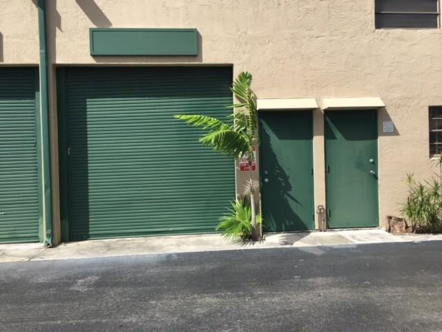 a couple of potted plants in front of door