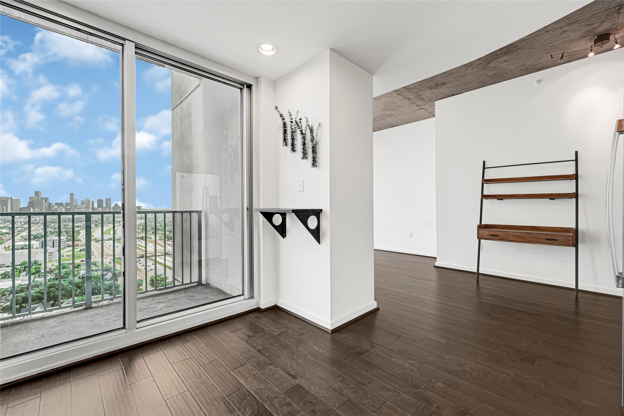 5925 Almeda Road, Unit 12403 Houston, TX 77004 - Photo 6 of 20 a view of an empty room with wooden floor and a window