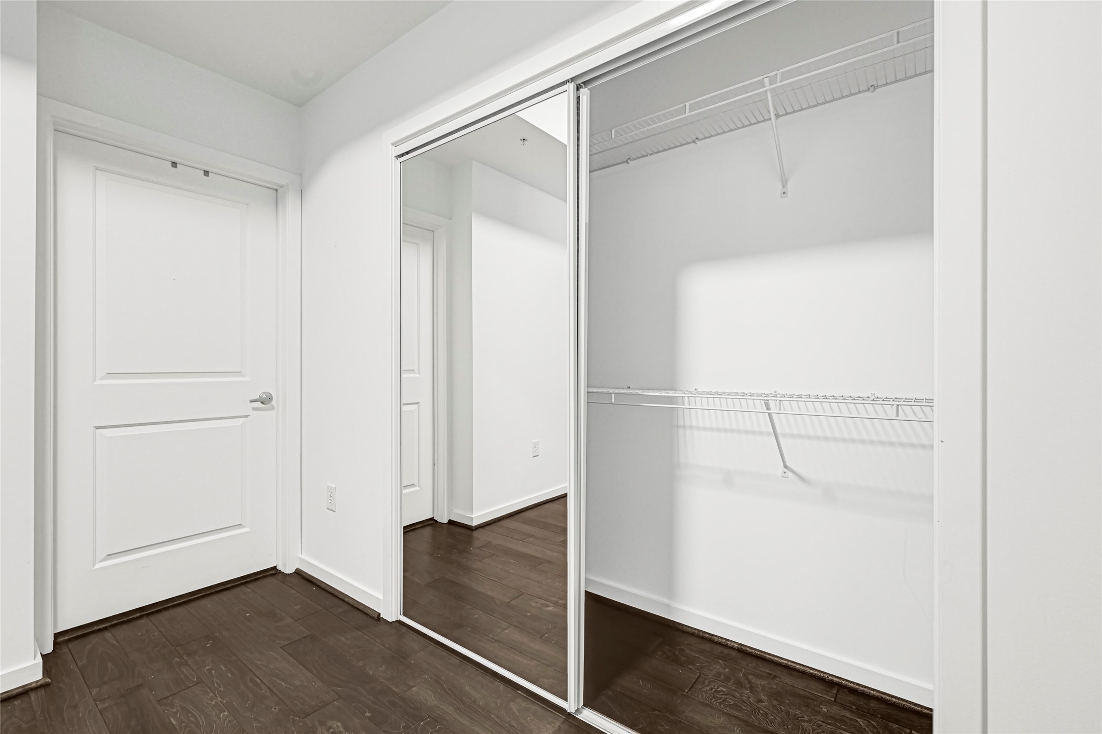 5925 Almeda Road, Unit 12403 Houston, TX 77004 - Photo 9 of 20 a view of an empty walk in closet with wooden floor