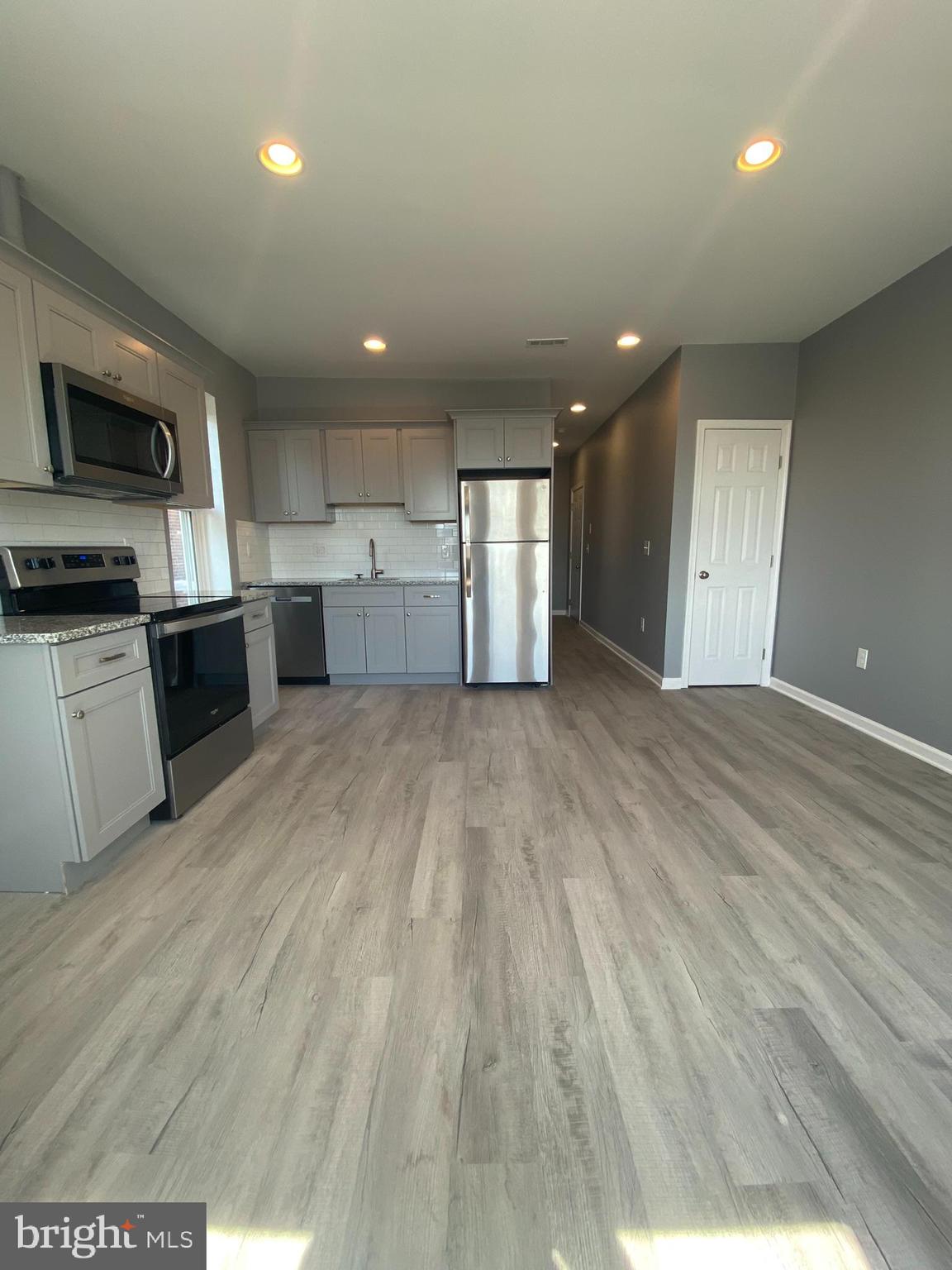 22 South 51st Street, Unit 3 Philadelphia, PA 19139 - Photo 4 of 12 a view of a kitchen with a sink and a microwave
