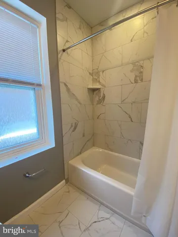 a white bath tub sitting next to a window