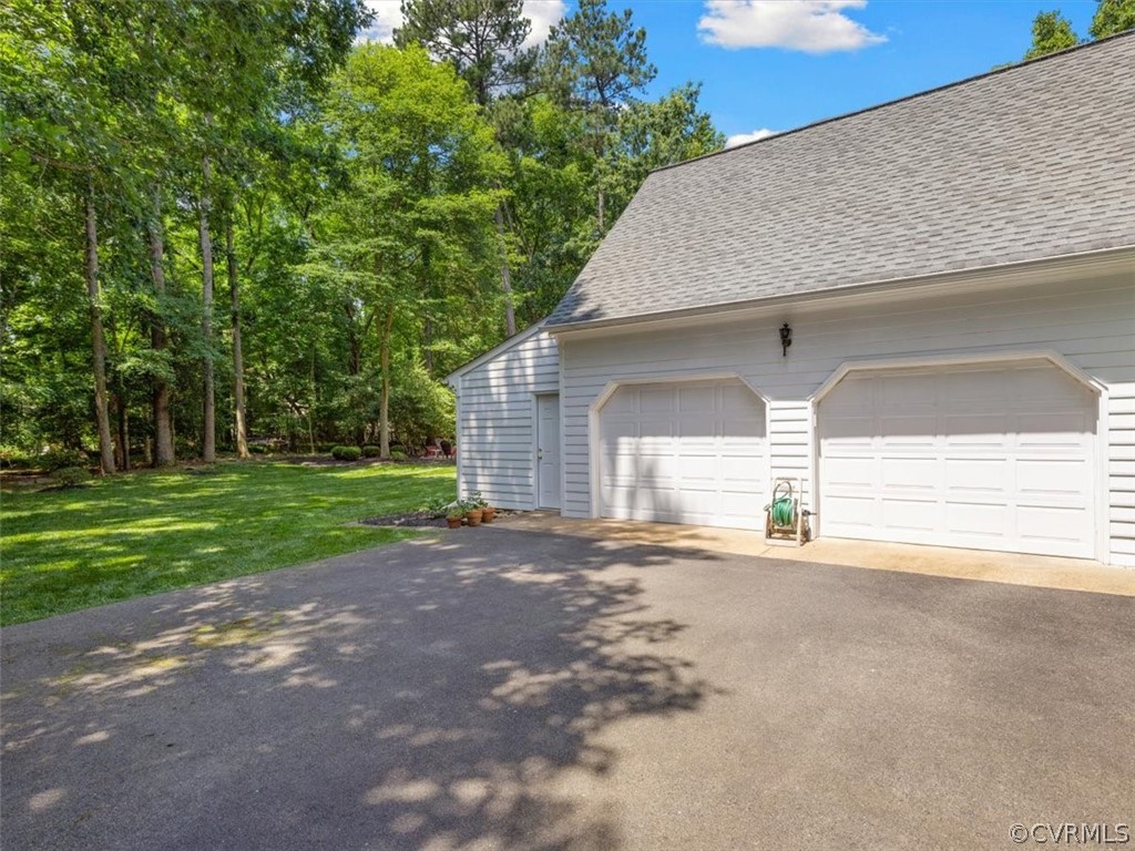 13807 Sunrise Bluff Road Midlothian, VA 23112 - Photo 34 of 40 a view of a house with garage and yard