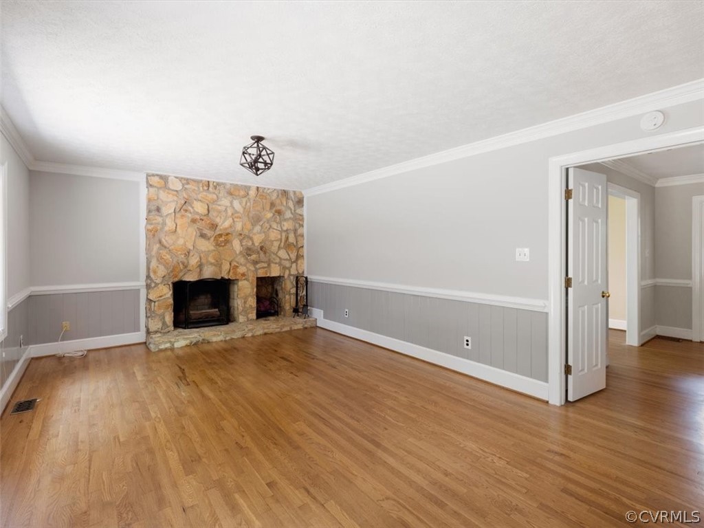 13807 Sunrise Bluff Road Midlothian, VA 23112 - Photo 9 of 40 an empty room with wooden floor and fireplace