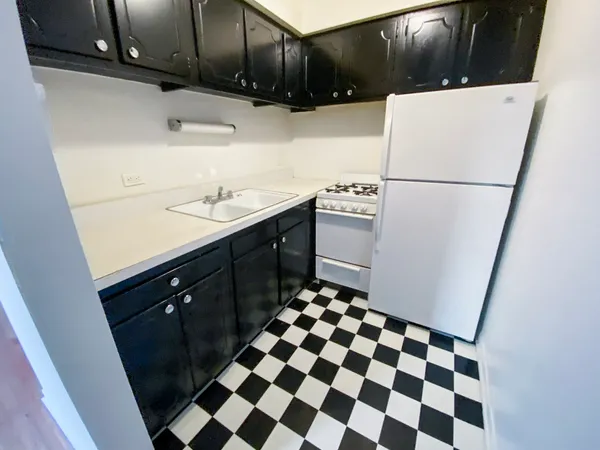 a kitchen with a sink a stove and a refrigerator