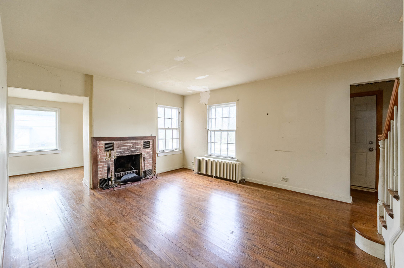 207 North Main Street Lombard, IL 60148 - Photo 3 of 15 a view of an empty room with a fireplace and a window