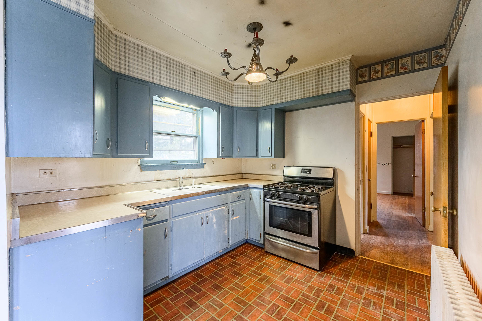 207 North Main Street Lombard, IL 60148 - Photo 6 of 15 a kitchen with stainless steel appliances granite countertop a sink cabinets and a stove