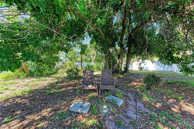 a backyard of a house with table and chairs