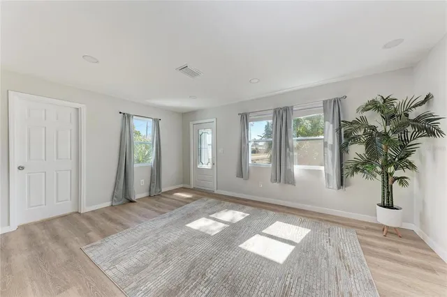 a view of a room that has a bed and a window