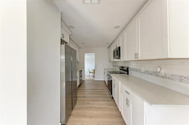 a kitchen with a sink and cabinets