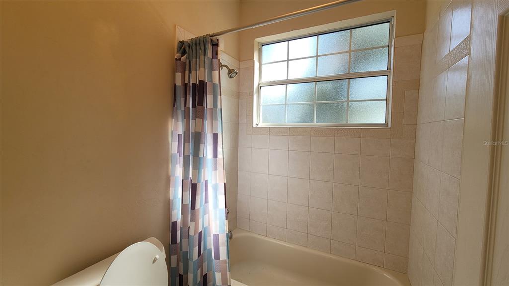 8762 Highway 26 Newberry, FL 32669 - Photo 13 of 63 a bathroom with a bathtub and shower