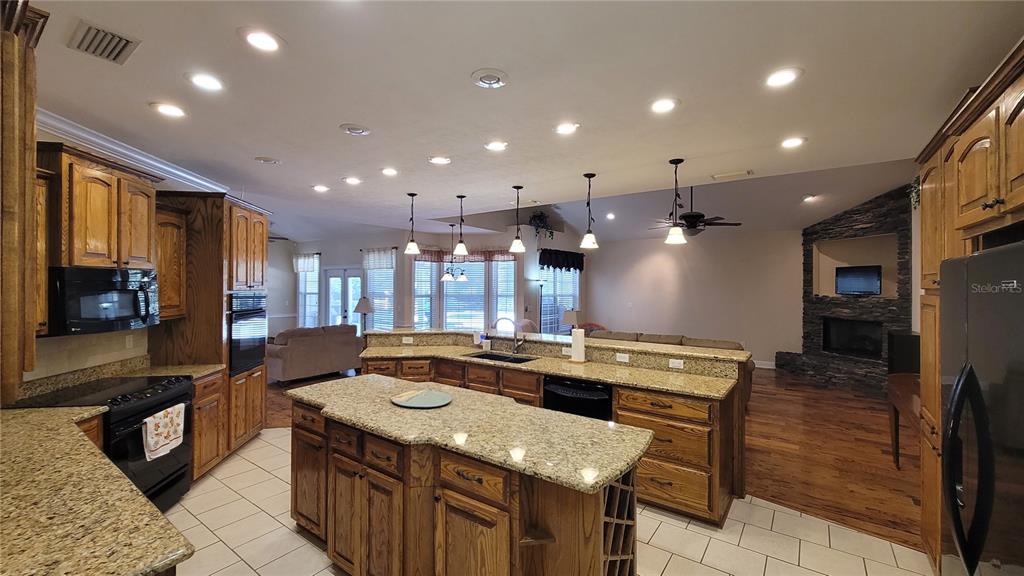 8762 Highway 26 Newberry, FL 32669 - Photo 16 of 63 a kitchen with stainless steel appliances granite countertop a sink stove and cabinets