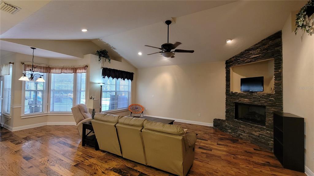 8762 Highway 26 Newberry, FL 32669 - Photo 18 of 63 a living room with furniture and a flat screen tv