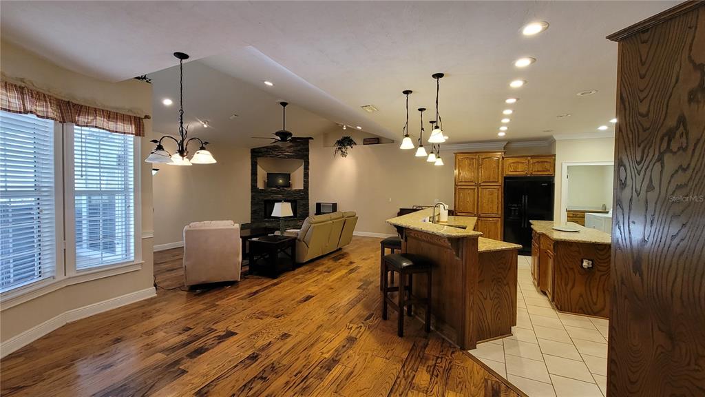 8762 Highway 26 Newberry, FL 32669 - Photo 20 of 63 a view of a dining room and livingroom with furniture wooden floor a chandelier
