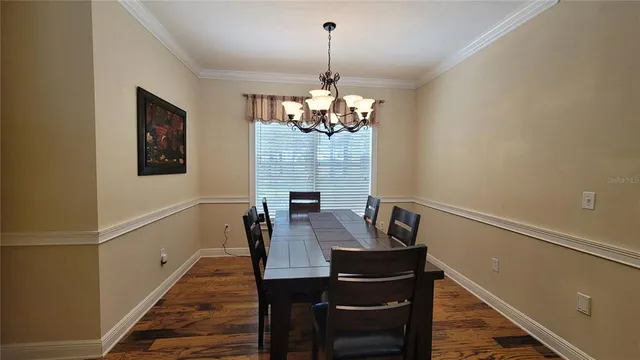 a living room with furniture a ceiling fan and a window