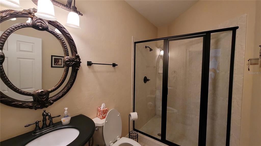8762 Highway 26 Newberry, FL 32669 - Photo 26 of 63 a bathroom with a sink mirror toilet and shower