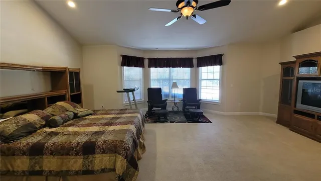 a bedroom with a bed dresser and a window