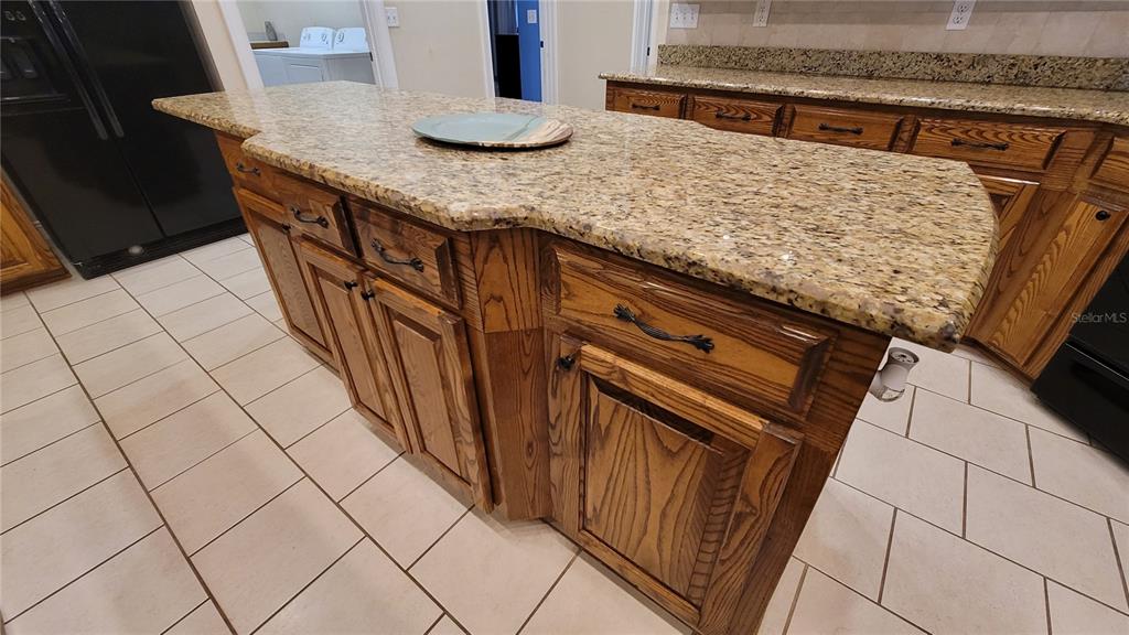 8762 Highway 26 Newberry, FL 32669 - Photo 42 of 63 a kitchen with granite countertop a sink and a stove