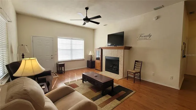 a view of a house with a yard and a large tree