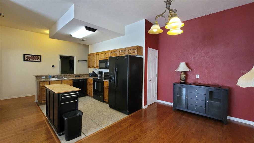 8762 Highway 26 Newberry, FL 32669 - Photo 48 of 63 a kitchen with stainless steel appliances a stove refrigerator and microwave