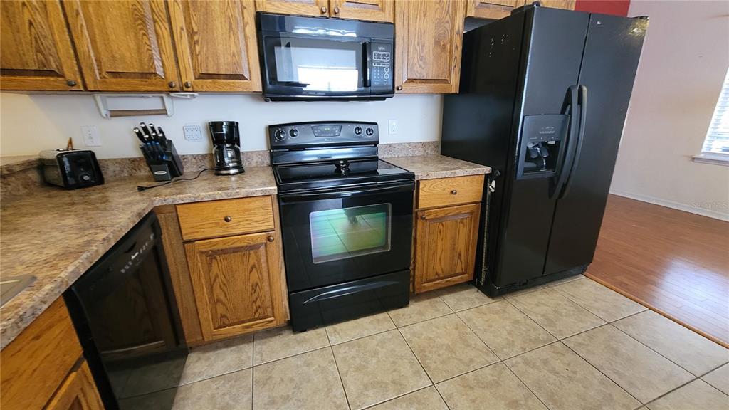 8762 Highway 26 Newberry, FL 32669 - Photo 49 of 63 a kitchen with stainless steel appliances granite countertop a refrigerator stove and sink