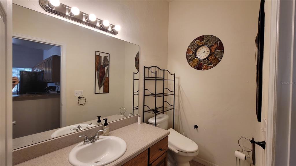 8762 Highway 26 Newberry, FL 32669 - Photo 51 of 63 a bathroom with a toilet a sink and mirror