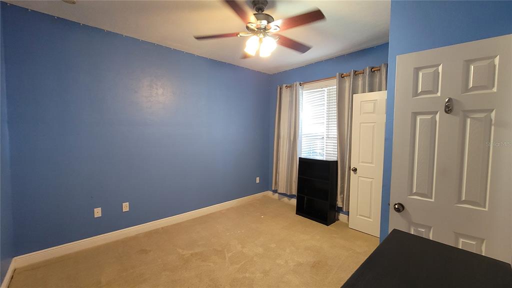 8762 Highway 26 Newberry, FL 32669 - Photo 10 of 63 wooden floor and window in an empty room