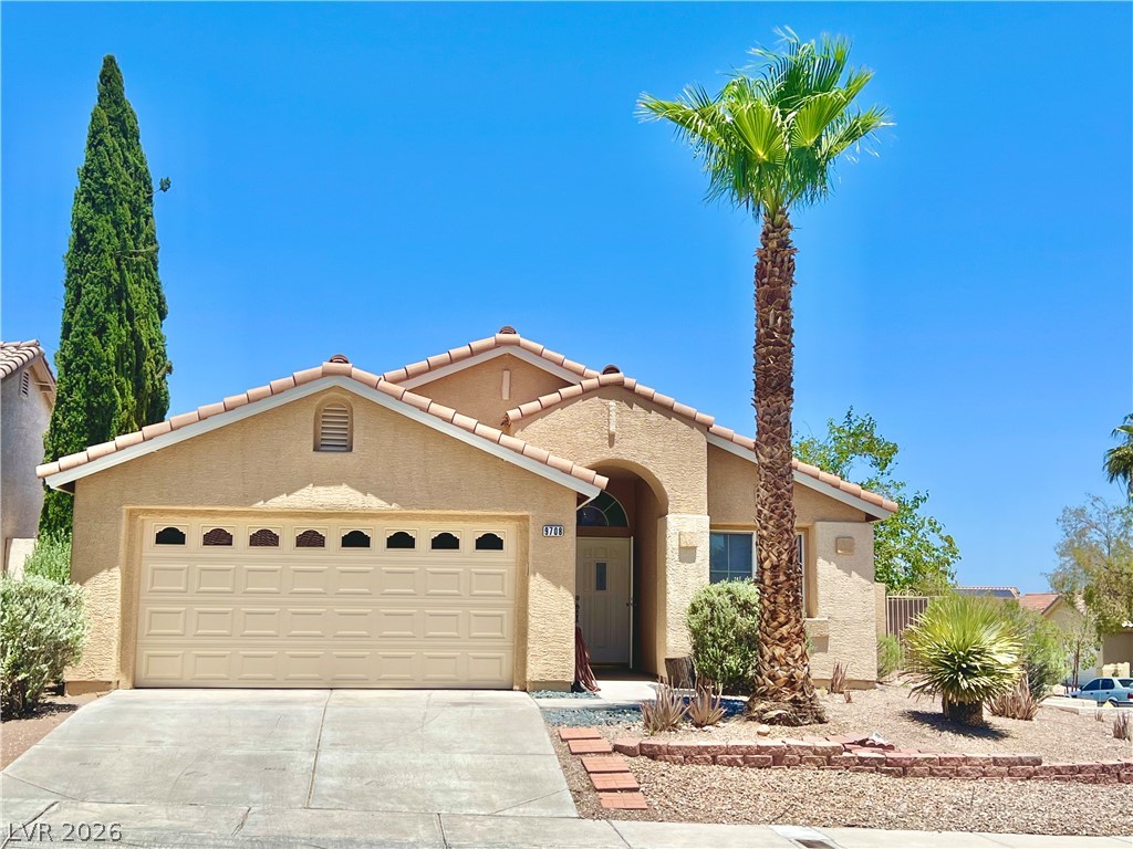 9708 Ridge Creek Place Las Vegas, NV 89134 - Photo 3 of 43 A charming stucco residence with a classic tile roof and xeriscaped front yard.