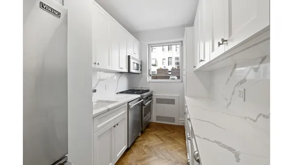 a kitchen with cabinets and a stove