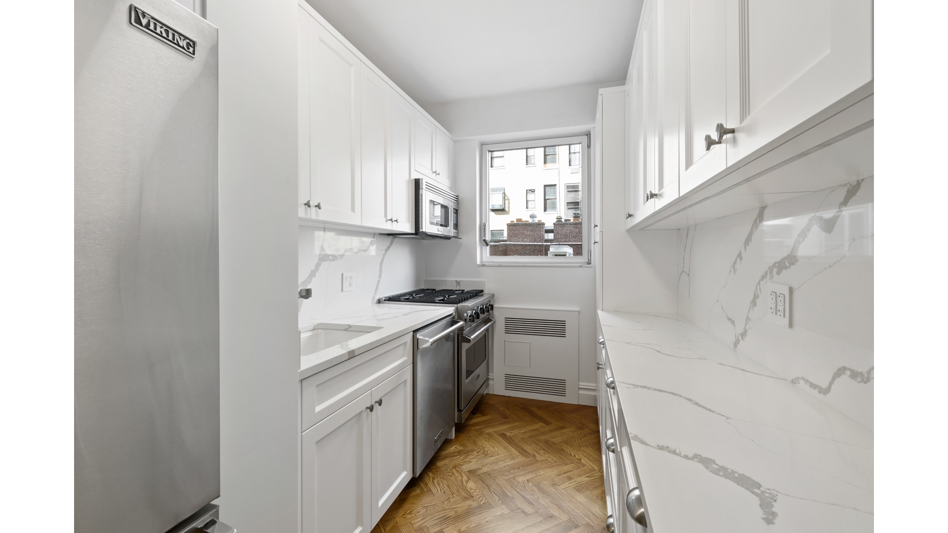 923 5th Avenue, Unit 9G Manhattan, NY 10021 - Photo 11 of 13 a kitchen with cabinets and a stove